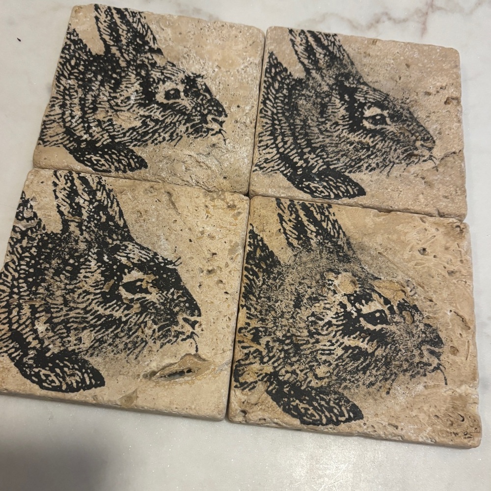 Set of four stone rabbit coasters